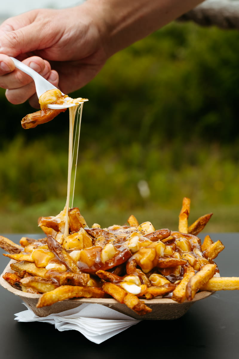 Classic Poutine — hand-cut fries, cheese curds and gravy with a cheese pull on the fork