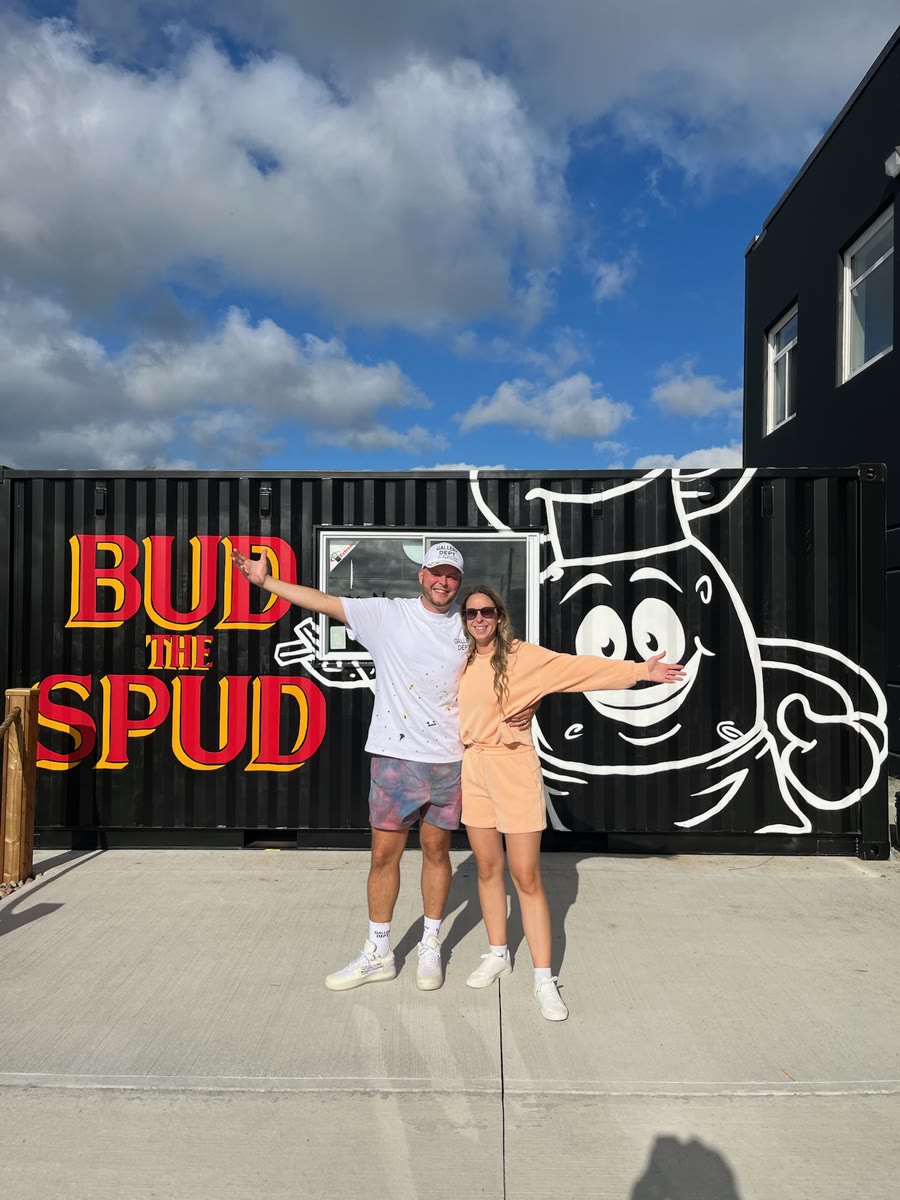 The current owners, Kyle and Kathleen Conrod, standing at the front of the original Bud the Spud truck