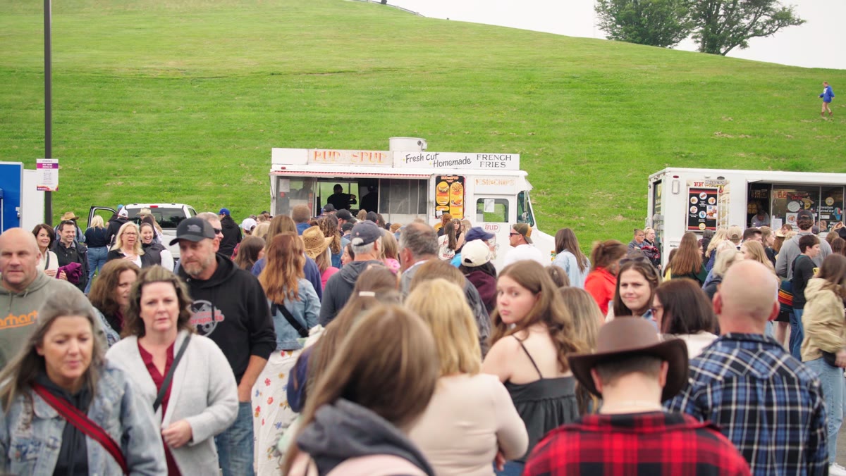 BUDtheSPUD truck serving a packed festival crowd on an outdoor field