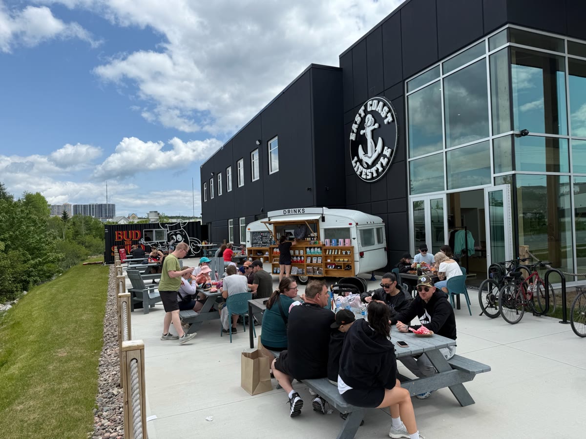BUDtheSPUD on site at an outdoor event — picnic tables full, the truck serving a crowd